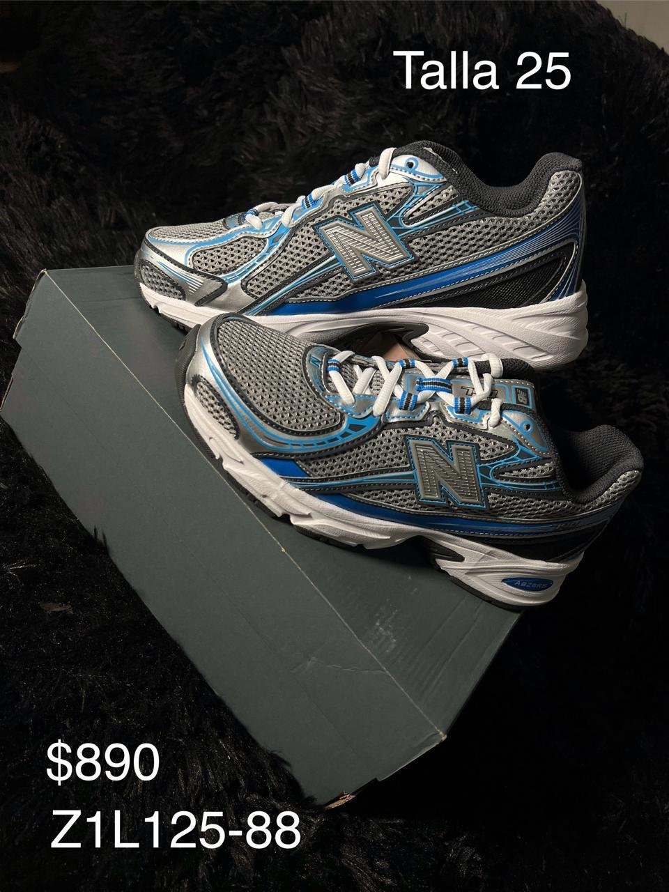 Tenis New Balance plata con azul talla 25 MX en su caja